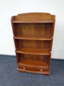 A set of reproduction bow fronted open bookshelves fitted a drawer