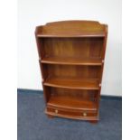 A set of reproduction bow fronted open bookshelves fitted a drawer