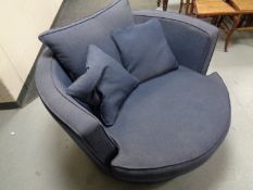 A cuddle chair upholstered in a blue fabric