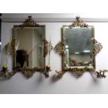 A pair of antique ornate brass framed bevel edged mirrors with candle sconces (as found)