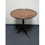 A 19th century mahogany tilt top occasional table on three way pedestal