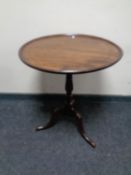 A 19th century mahogany tilt top occasional table on three way pedestal