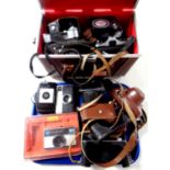 A leather camera bag and a tray containing a quantity of assorted cameras to include Kodak, Zenit,