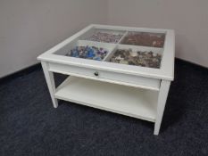 An Ikea display coffee table fitted a drawer containing pebbles,
