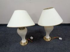 A pair of ceramic and brass table lamps with shades