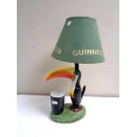 A Carlton ware Guinness toucan table lamp with shade