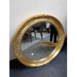 A contemporary circular gilt framed bevel edged mirror