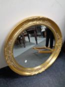 A contemporary circular gilt framed bevel edged mirror