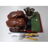 A tray containing wooden elephants together with a large quantity of stainless steel and plated