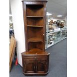 A St Michael's Furniture oak corner shelves fitted double door cupboard and drawer beneath