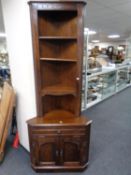 A St Michael's Furniture oak corner shelves fitted double door cupboard and drawer beneath