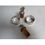 A pair of Sheffield silver napkin rings together with a pair of silver wine cork toppers