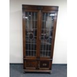 An early 20th century oak double door bookcase with leaded glass doors (as found)