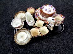 A tray containing antique tea ware to include copper lustre teacups and milk jug,