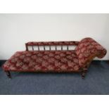 A 19th century chaise longue upholstered in a red floral fabric