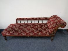 A 19th century chaise longue upholstered in a red floral fabric