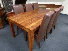 A contemporary extending dining table with leaf together with a set of six high backed brown