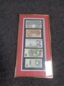 A frame containing five English bank notes