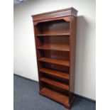 A set of open bookshelves in a mahogany finish