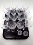 A tray containing a set of sixteen wine glasses together with two cut glass vases