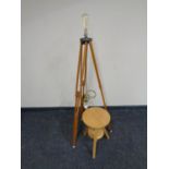 A circular pine adjustable stool together with a tripod stand converted into a standard lamp