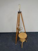 A circular pine adjustable stool together with a tripod stand converted into a standard lamp