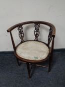 An early 20th century beech oval elbow chair