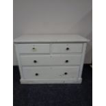 An antique pine painted four drawer chest