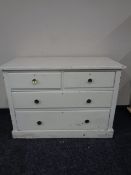 An antique pine painted four drawer chest