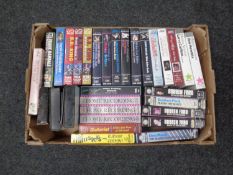 A box containing guitar instruction video cassettes