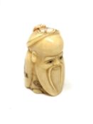 A carved Chinese bone netsuke - Wise man with beard