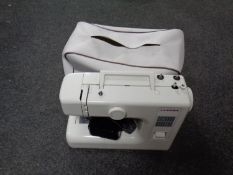 A Janome electric sewing machine with pedal and lead