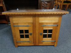 An early 20th century oak double door wall cabinet
