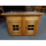 An early 20th century oak double door wall cabinet