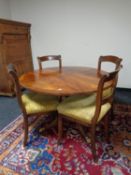 A Regency style circular mahogany table together with four antique chairs