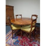 A Regency style circular mahogany table together with four antique chairs