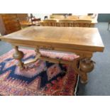 A continental oak pull out dining room table on bulbous legs