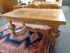 A continental oak pull out dining room table on bulbous legs