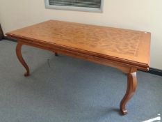 A heavy quality reproduction pull out dining table