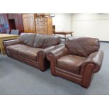 A three seater brown leather settee with matching armchair