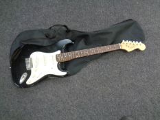 A Liberty 303 Stratocaster style electric guitar in soft carry case together with a further empty