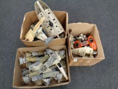 Three boxes containing a collection of Star Wars model parts, imperial walkers,