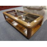 A contemporary glass topped coffee table