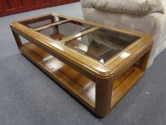 A contemporary glass topped coffee table