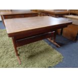 A mid century pull out dining room table together with six carved oak dining chairs