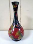 An antique William Moorcroft vase decorated with pomegranates