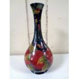 An antique William Moorcroft vase decorated with pomegranates