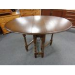 A reproduction oak gate leg table