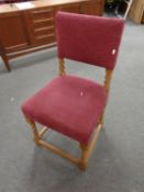 An oak chair upholstered in burgandy fabric