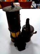Two vintage 20th century miner's lamps together with a coal miner's figure